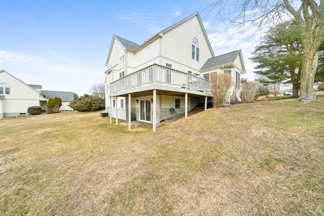 back of property with a yard and a wooden deck