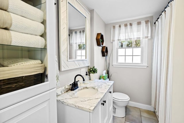 bathroom featuring vanity, tile patterned floors, baseboards, toilet, and a shower with shower curtain