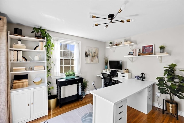 office featuring baseboards, a chandelier, and wood finished floors