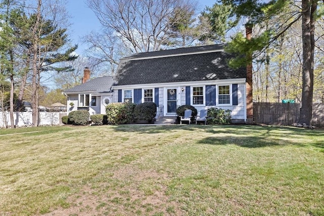 dutch colonial featuring fence, roof with shingles, a front yard, entry steps, and a chimney