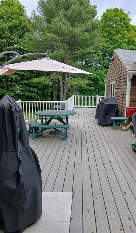 64 Broad St, Rehoboth, MA 02769 - wooden deck featuring outdoor dining area and view of scattered trees