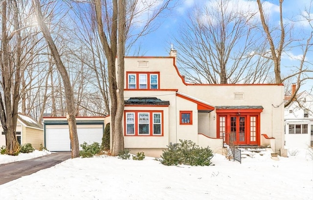 view of front of house featuring a chimney and stucco siding