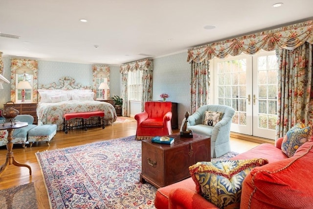 bedroom featuring french doors, light wood-type flooring, and access to outside