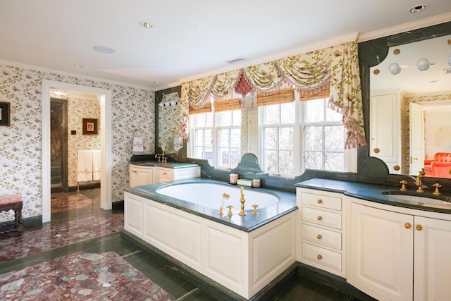 bathroom featuring ornamental molding, a washtub, and vanity