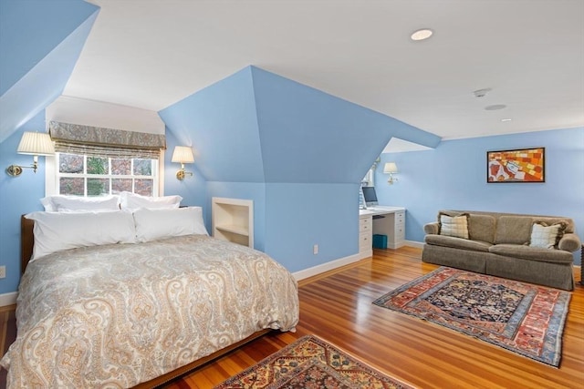 bedroom with lofted ceiling and hardwood / wood-style floors