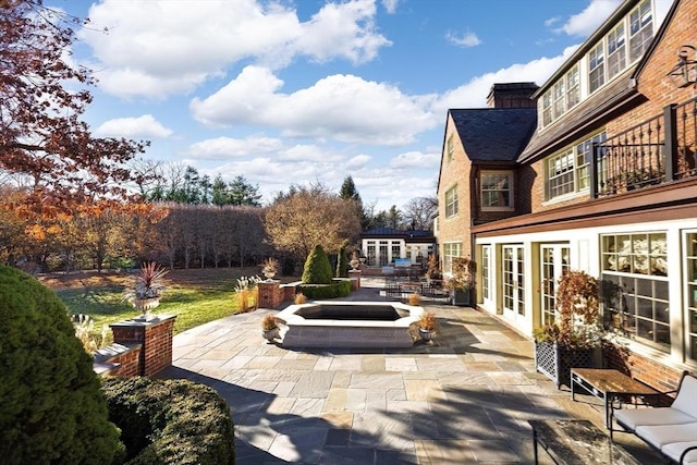 view of patio / terrace with a fire pit and french doors