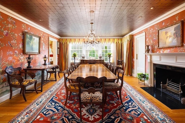 dining room featuring wood ceiling, ornamental molding, and light hardwood / wood-style floors