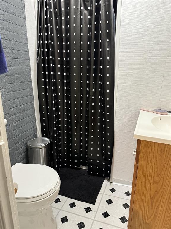 72 Wright St, Stoneham, MA 02180 - bathroom with tile patterned floors, vanity, toilet, and a shower with shower curtain