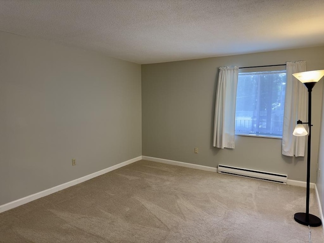 carpeted empty room featuring baseboards, a textured ceiling, and baseboard heating