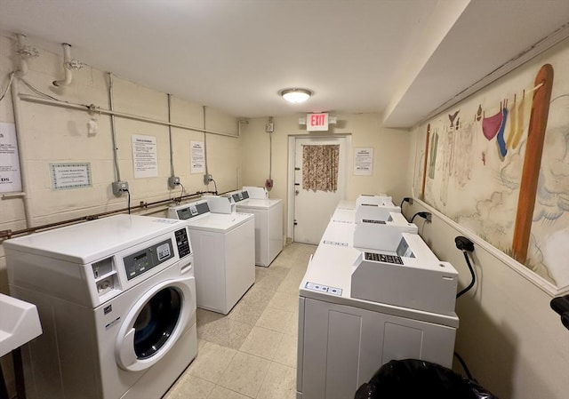 community laundry room featuring washing machine and clothes dryer