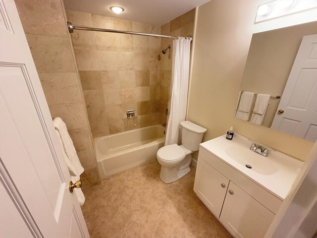 full bathroom with shower / bath combo with shower curtain, toilet, and vanity