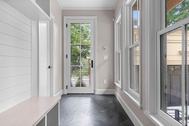 doorway to outside with dark tile patterned flooring and crown molding