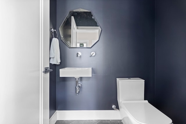 bathroom featuring tile patterned flooring and toilet