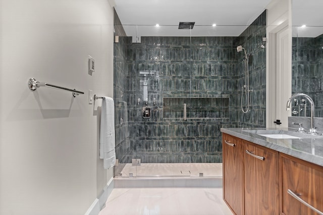 bathroom with tile patterned floors, a shower with shower door, and vanity