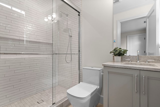 bathroom featuring a shower with door, toilet, and vanity