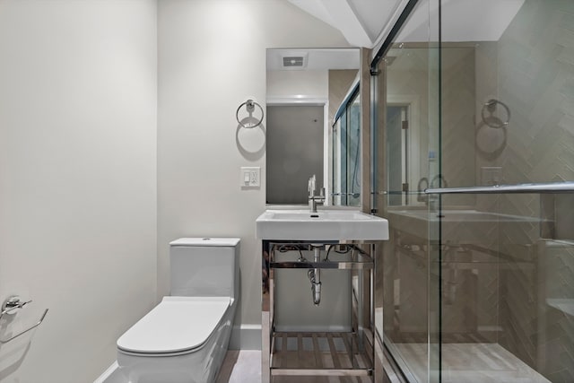 bathroom featuring vanity, walk in shower, and toilet