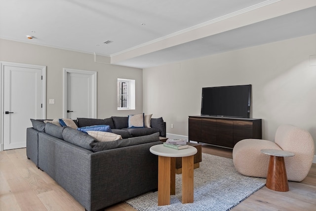 living room with crown molding and light hardwood / wood-style floors