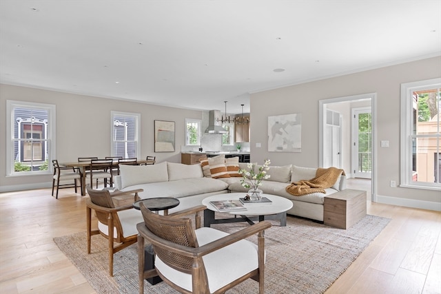 living room featuring light hardwood / wood-style flooring and ornamental molding