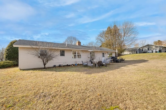 rear view of house with a lawn