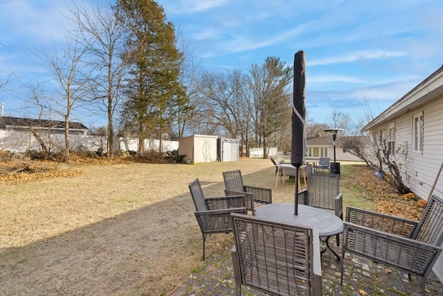 view of yard with a patio and a storage unit