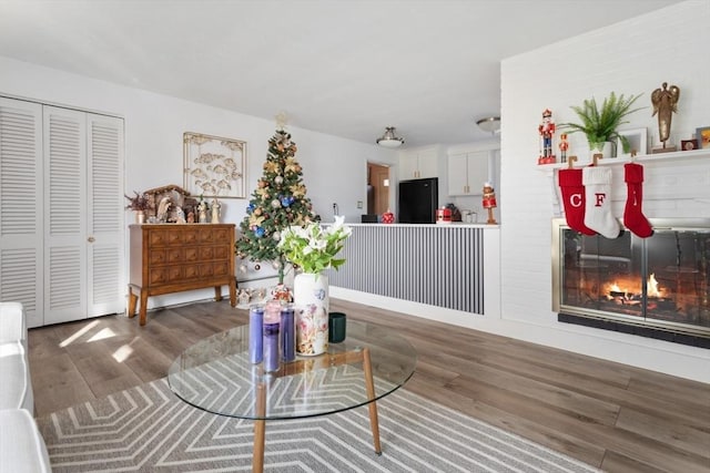 sitting room with a fireplace and dark hardwood / wood-style floors