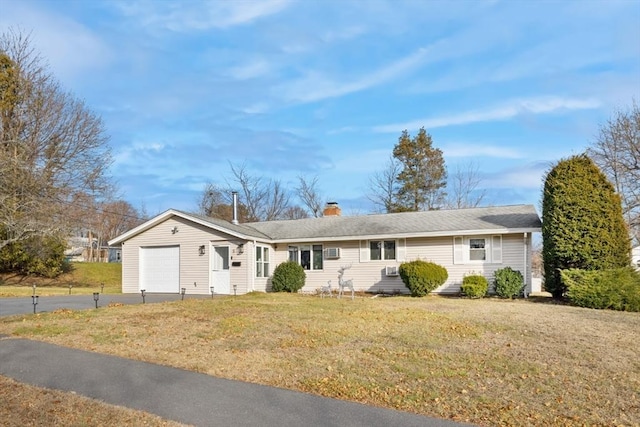 ranch-style home with a front yard and a garage