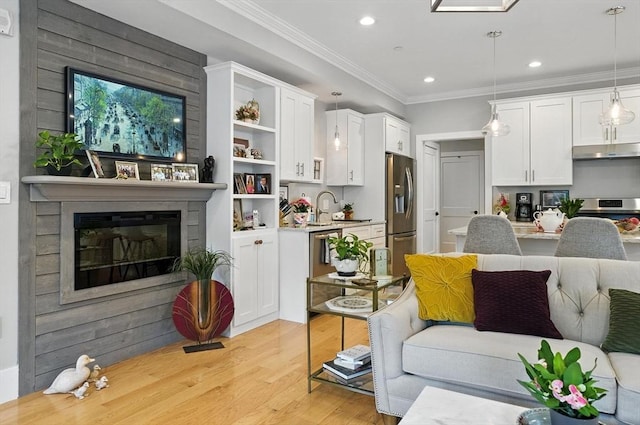 132 High St Unit B, Newburyport, MA 01950 - living room featuring light wood-style flooring, recessed lighting, crown molding, and a large fireplace