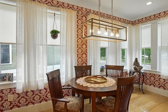 132 High St Unit B, Newburyport, MA 01950 - dining space featuring healthy amount of natural light, wallpapered walls, wood finished floors, and crown molding