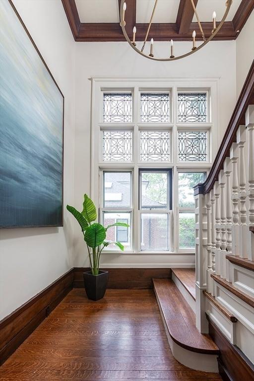 151 Salisbury Rd, Brookline, MA 02445 - foyer entrance with a chandelier, crown molding, wood finished floors, and stairs