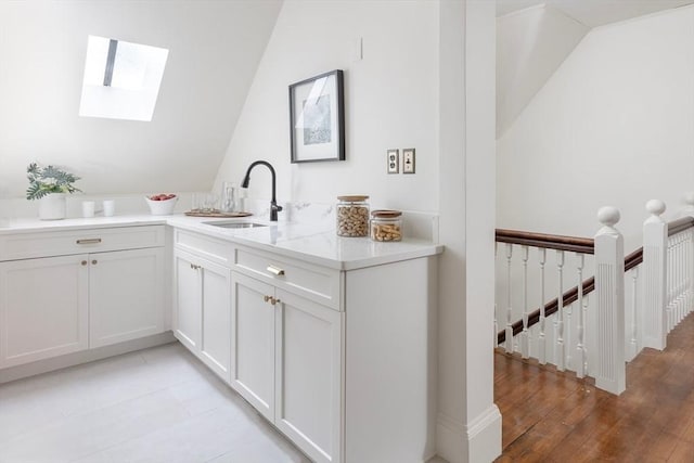 151 Salisbury Rd, Brookline, MA 02445 - bar area featuring a skylight, vaulted ceiling, and light wood finished floors