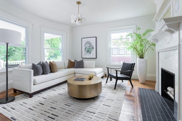 151 Salisbury Rd, Brookline, MA 02445 - living room featuring healthy amount of natural light, wood finished floors, ornamental molding, a chandelier, and a fireplace with flush hearth