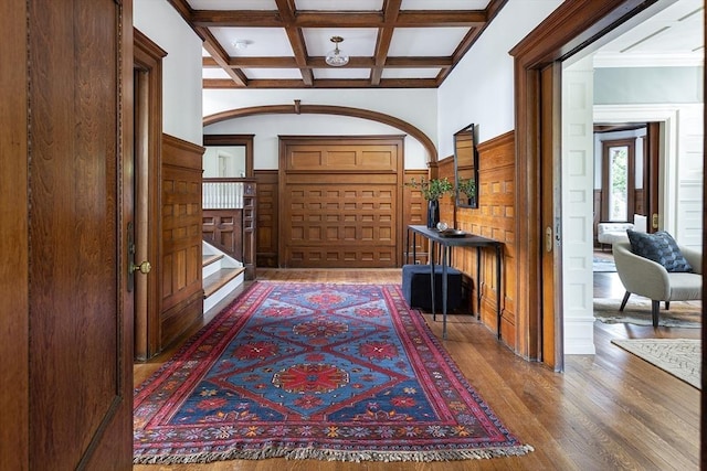 151 Salisbury Rd, Brookline, MA 02445 - entryway with coffered ceiling, wood finished floors, beam ceiling, stairs, and a wainscoted wall
