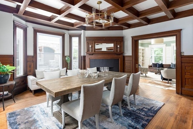 151 Salisbury Rd, Brookline, MA 02445 - dining space featuring beam ceiling, light wood-type flooring, a wainscoted wall, coffered ceiling, and a chandelier