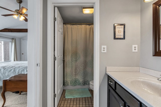 ensuite bathroom with toilet, ensuite bath, ceiling fan, tile patterned flooring, and vanity