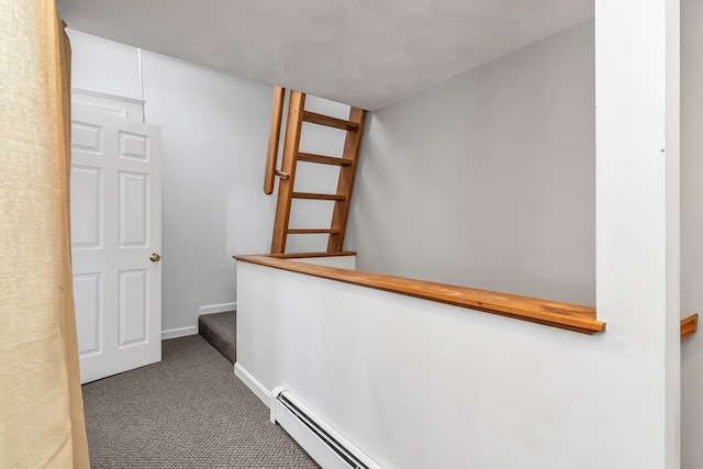 hallway with carpet floors, stairway, and baseboards