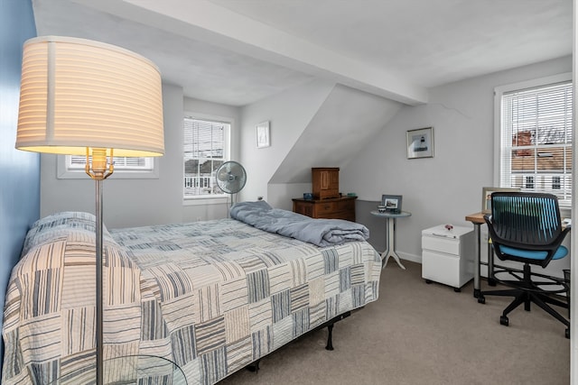 bedroom featuring baseboards, multiple windows, lofted ceiling with beams, and carpet flooring