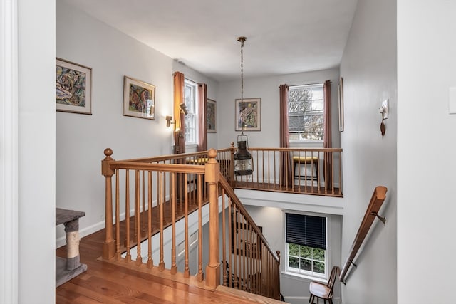 stairway featuring baseboards and wood finished floors