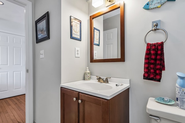 half bathroom featuring vanity and wood finished floors