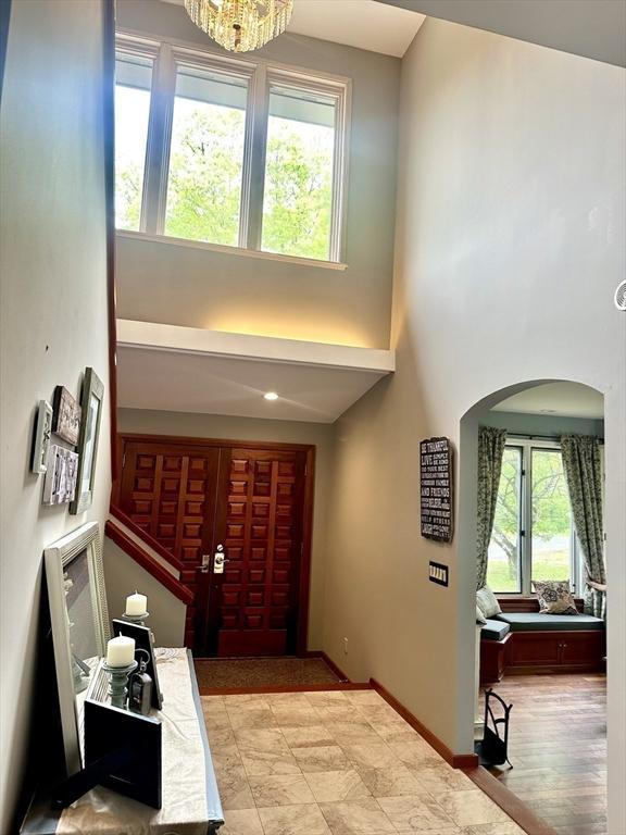 201 Main Rd, Williamsburg, MA 01039 - entryway with a towering ceiling, arched walkways, baseboards, and a chandelier