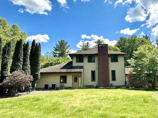 201 Main Rd, Williamsburg, MA 01039 - rear view of property featuring a chimney, a lawn, and central AC unit