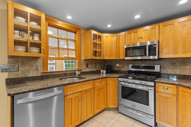 9 Oak St, Wayland, MA 01778 - kitchen with appliances with stainless steel finishes, a sink, glass insert cabinets, dark stone countertops, and backsplash