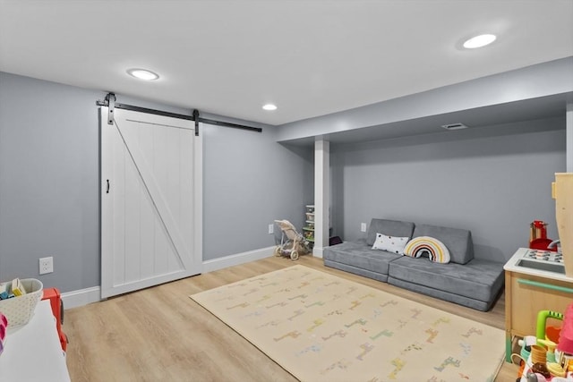 9 Oak St, Wayland, MA 01778 - rec room featuring wood finished floors, baseboards, a barn door, and recessed lighting