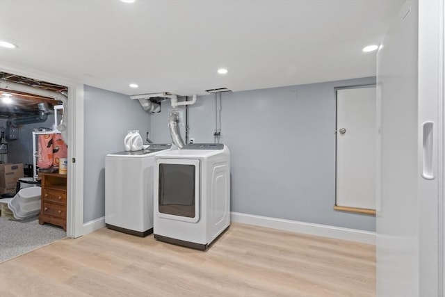 9 Oak St, Wayland, MA 01778 - laundry room featuring washing machine and dryer, light wood finished floors, baseboards, and recessed lighting