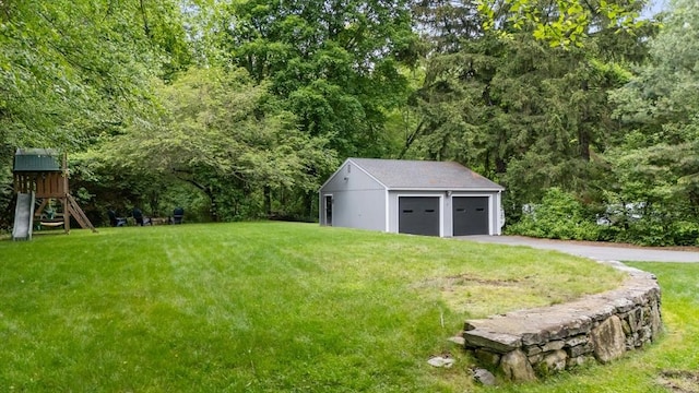 9 Oak St, Wayland, MA 01778 - view of grassy yard featuring a garage, an outbuilding, a playground, and a wooded view