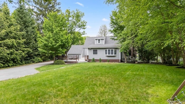 9 Oak St, Wayland, MA 01778 - view of front of home featuring a deck and a front lawn