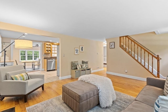 9 Oak St, Wayland, MA 01778 - living area featuring stairway, light wood-style flooring, and baseboards