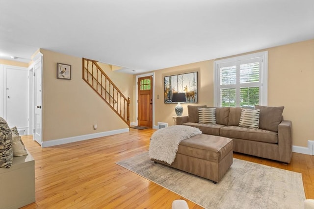 9 Oak St, Wayland, MA 01778 - living area featuring plenty of natural light, wood finished floors, stairway, and baseboards