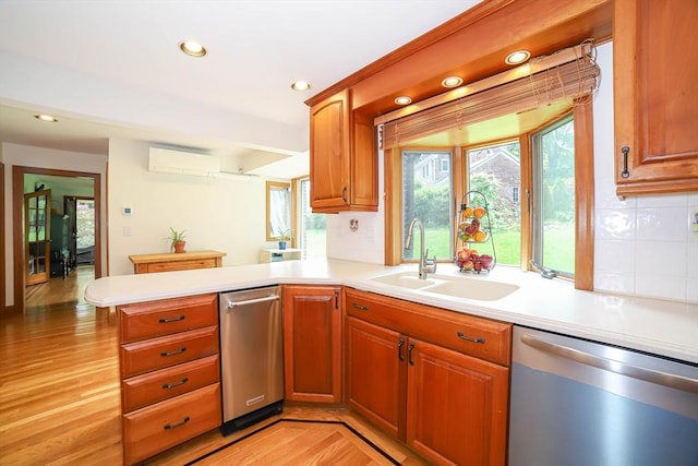 493 Salisbury St, Worcester, MA 01609 - kitchen with dishwasher, a sink, light countertops, a peninsula, and a wall mounted air conditioner