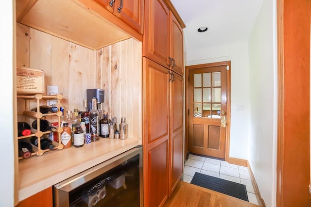 493 Salisbury St, Worcester, MA 01609 - indoor dry bar featuring wine cooler, light tile patterned flooring, and baseboards