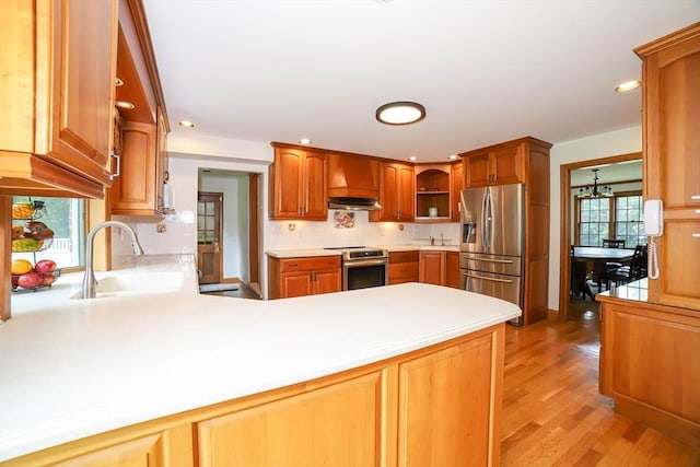 493 Salisbury St, Worcester, MA 01609 - kitchen featuring stainless steel appliances, a sink, a peninsula, open shelves, and premium range hood